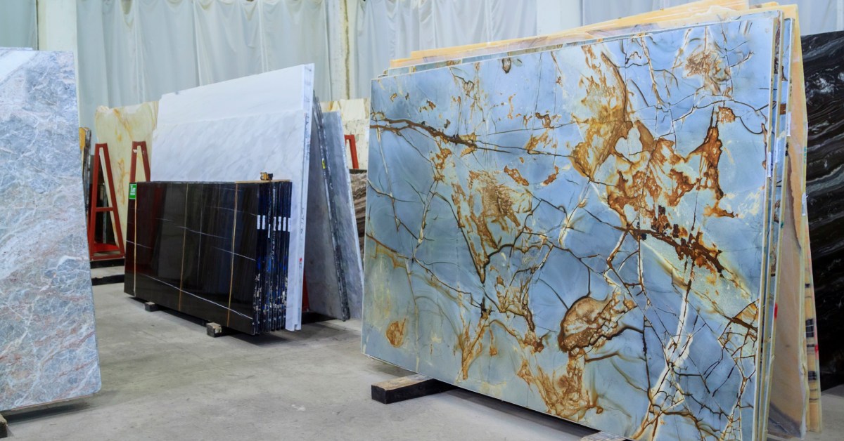 A storage space for quartzite slabs for sale. The stands feature multiple stone slabs of various colors and sizes.