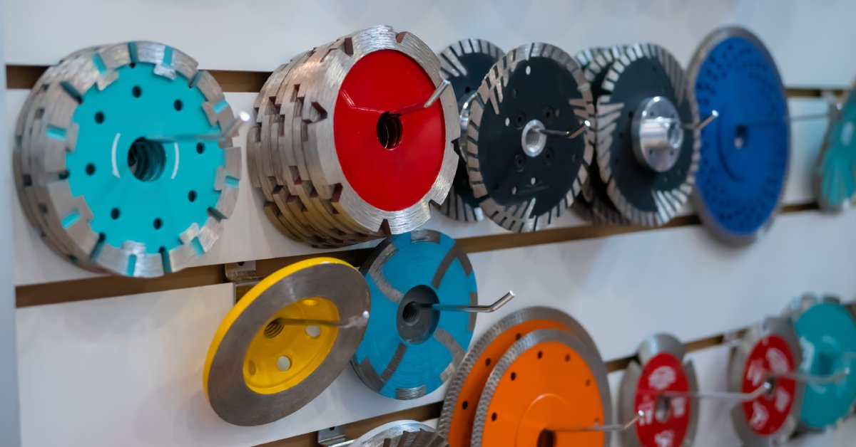 A retail display of diamond carving discs for bridge saws. The display includes discs of various colors and sizes.